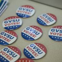GVSU Votes buttons scattered on the table
